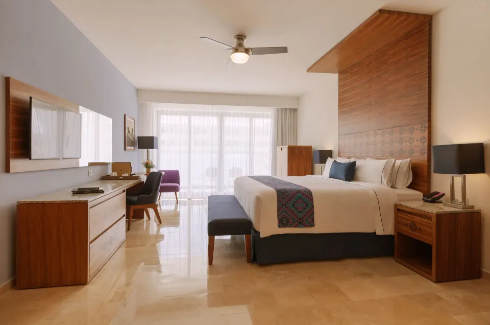 Agatha guest room with king bed and desk at Sensira Resort & Spa Riviera Maya.
