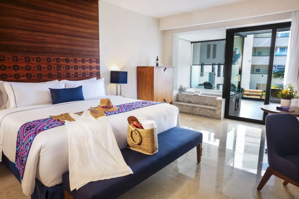 Amber Room king bed with balcony and soaking tub at Sensira Resort & Spa Riviera Maya.