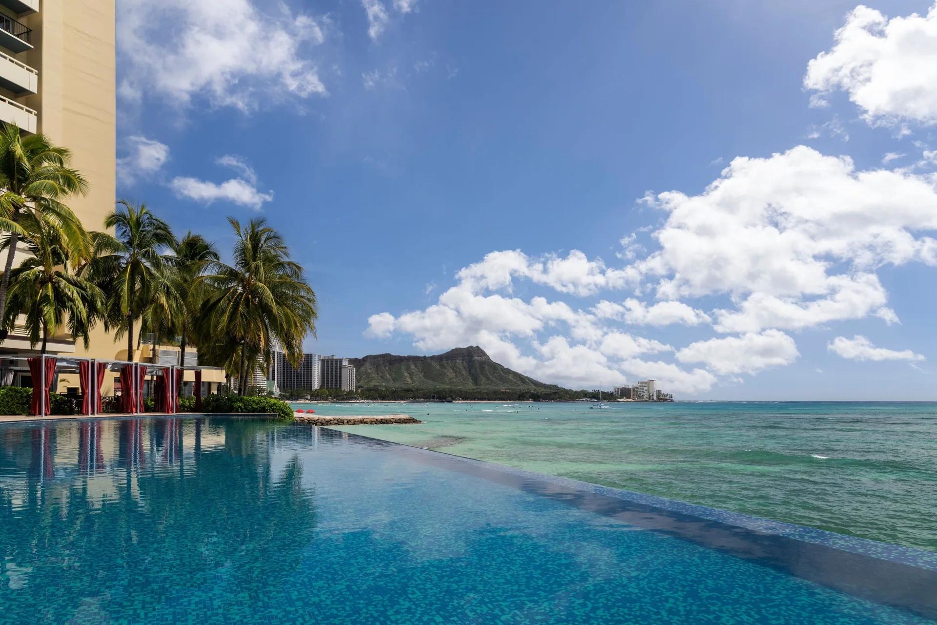 Infinity pool edge beside the ocean and Diamond Head at Sheraton Waikiki Beach Resort.
