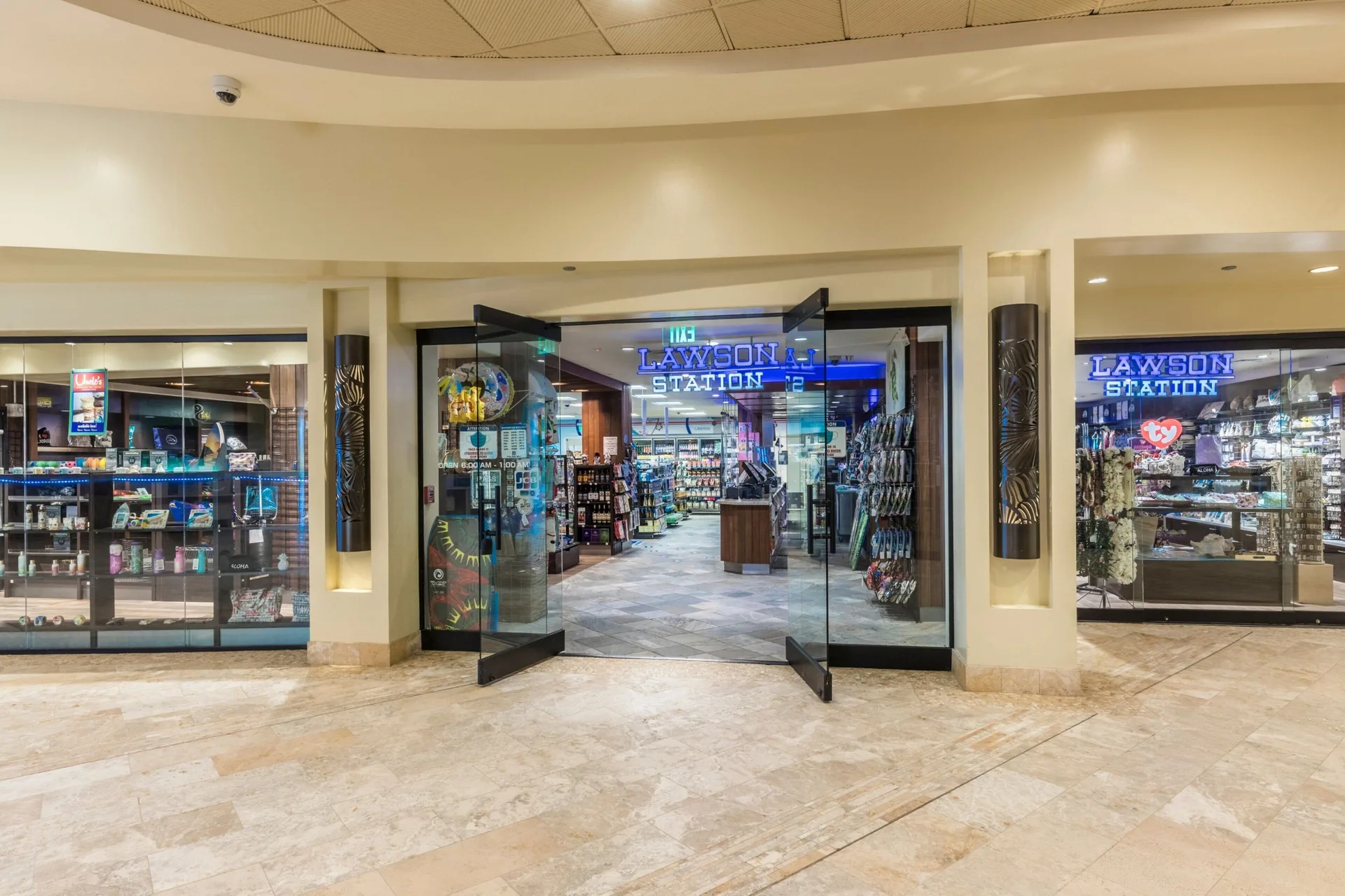 A lobby-level convenience shop entrance at Sheraton Waikiki Beach Resort with glass storefronts.