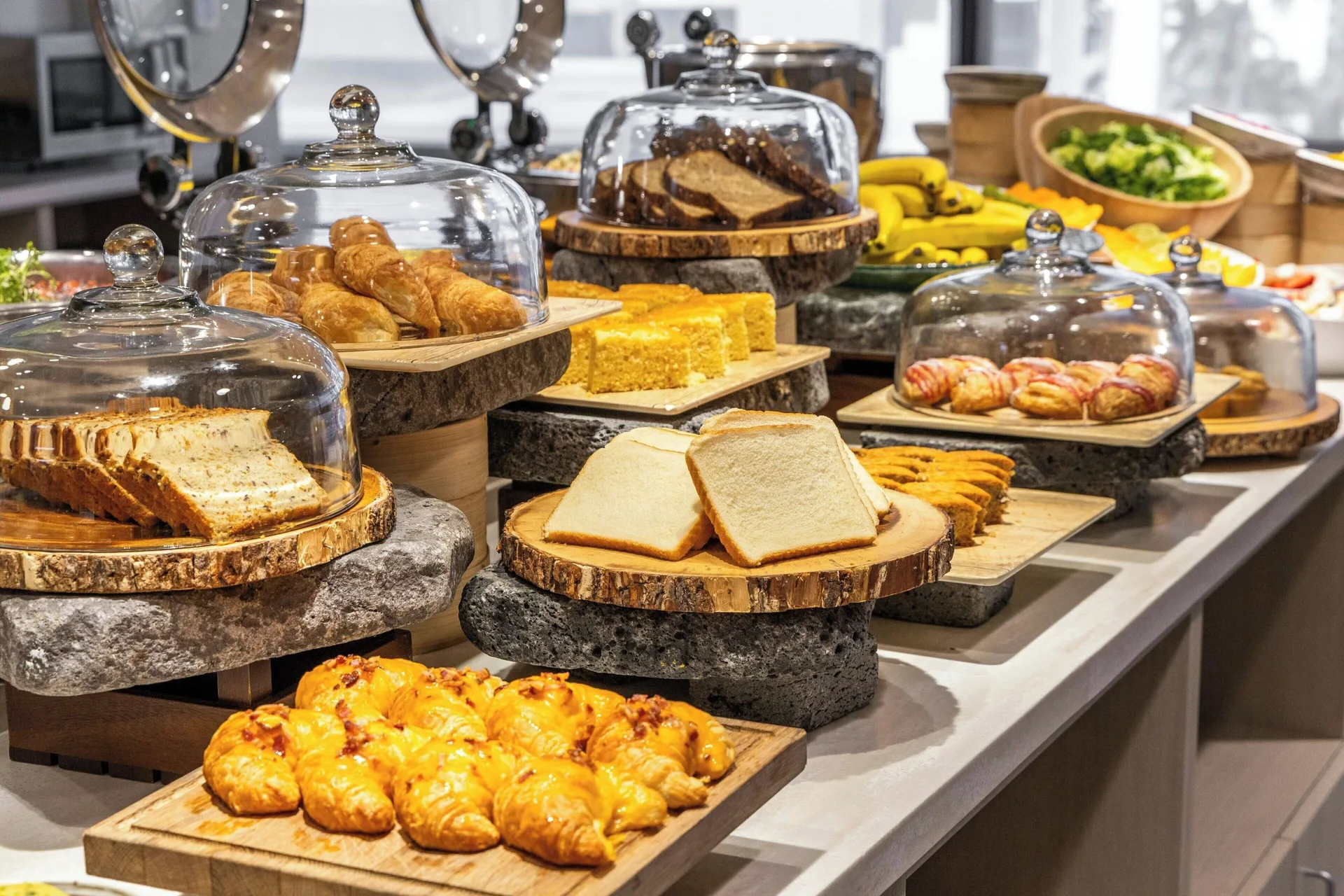 Breakfast pastries and breads displayed under glass at Sheraton Waikiki Beach Resort.