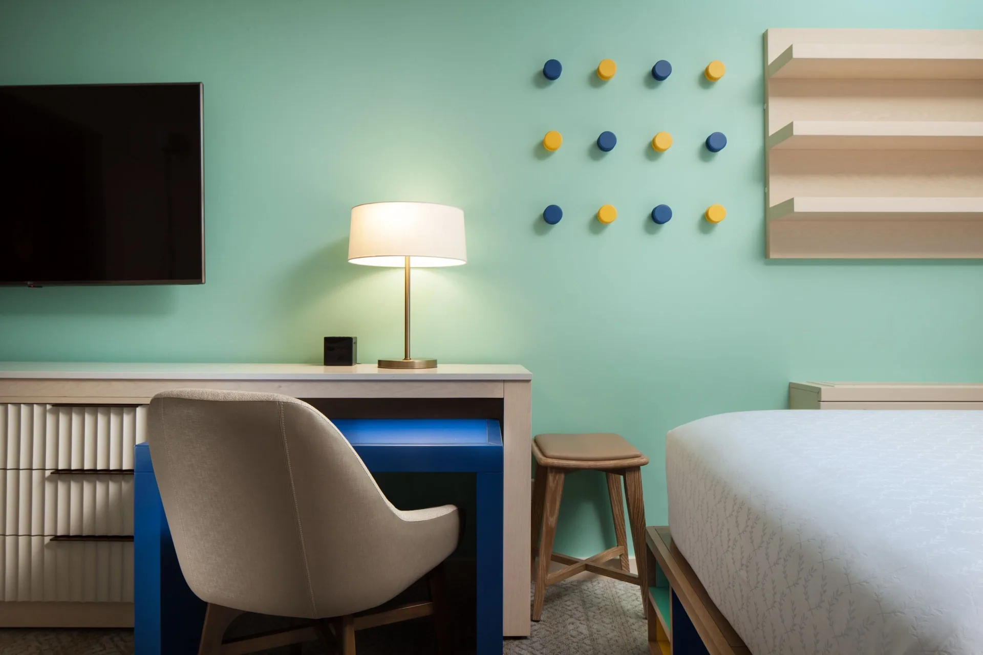 Desk, TV, and bed detail in a Family Room with multiple beds at Sheraton Waikiki Beach Resort.