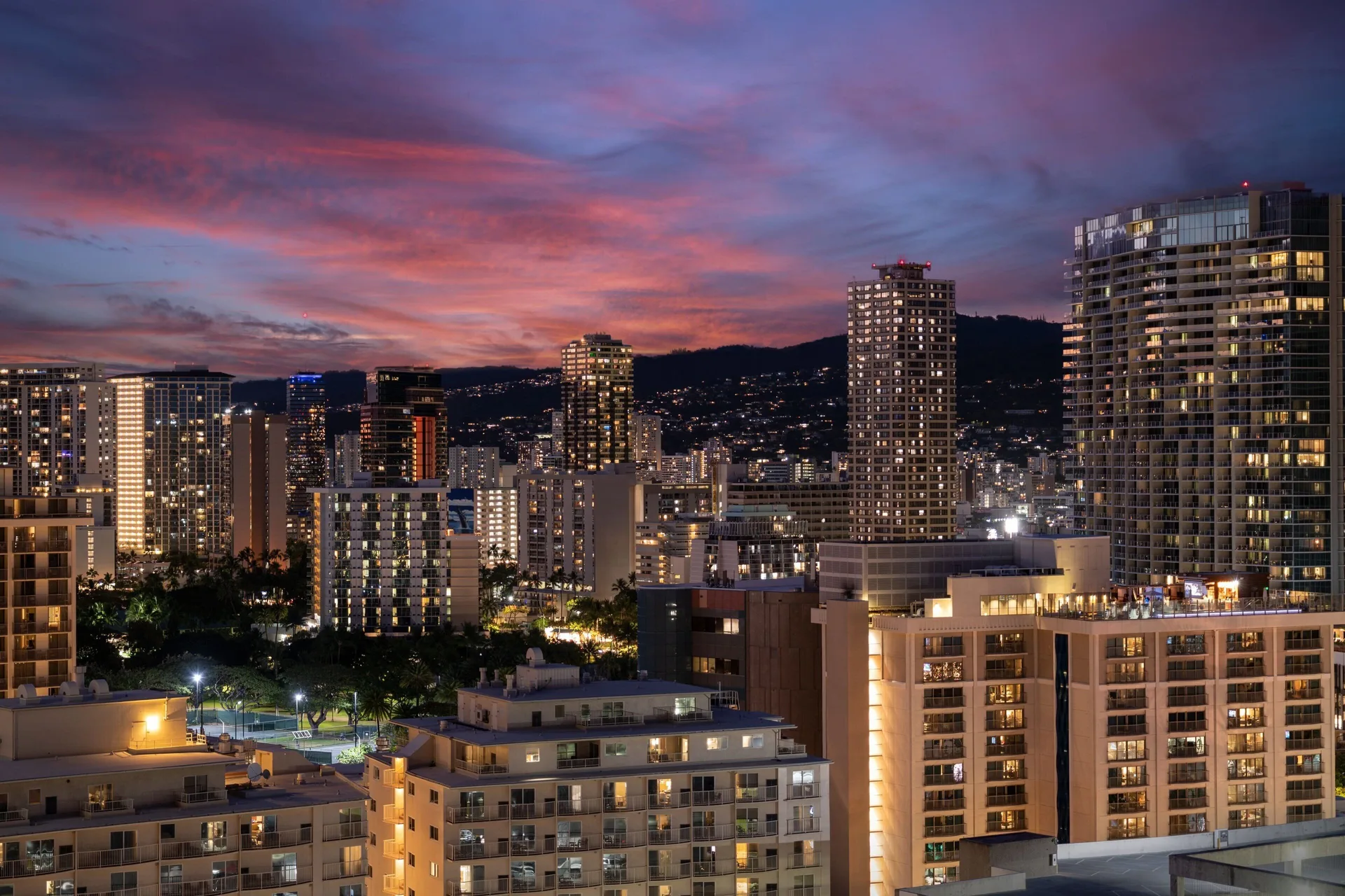 City skyline at sunset from the Family Room City View at Sheraton Waikiki Beach Resort.