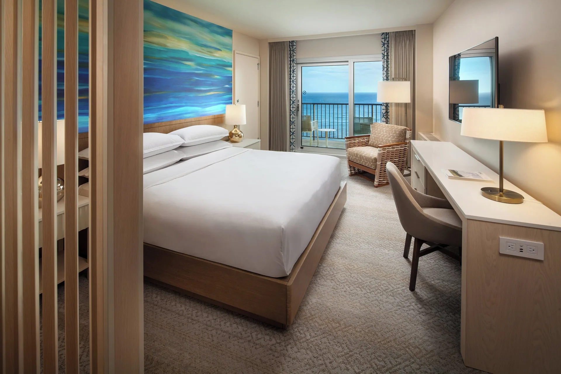 Penthouse oceanfront king bedroom with balcony view at Sheraton Waikiki Beach Resort.