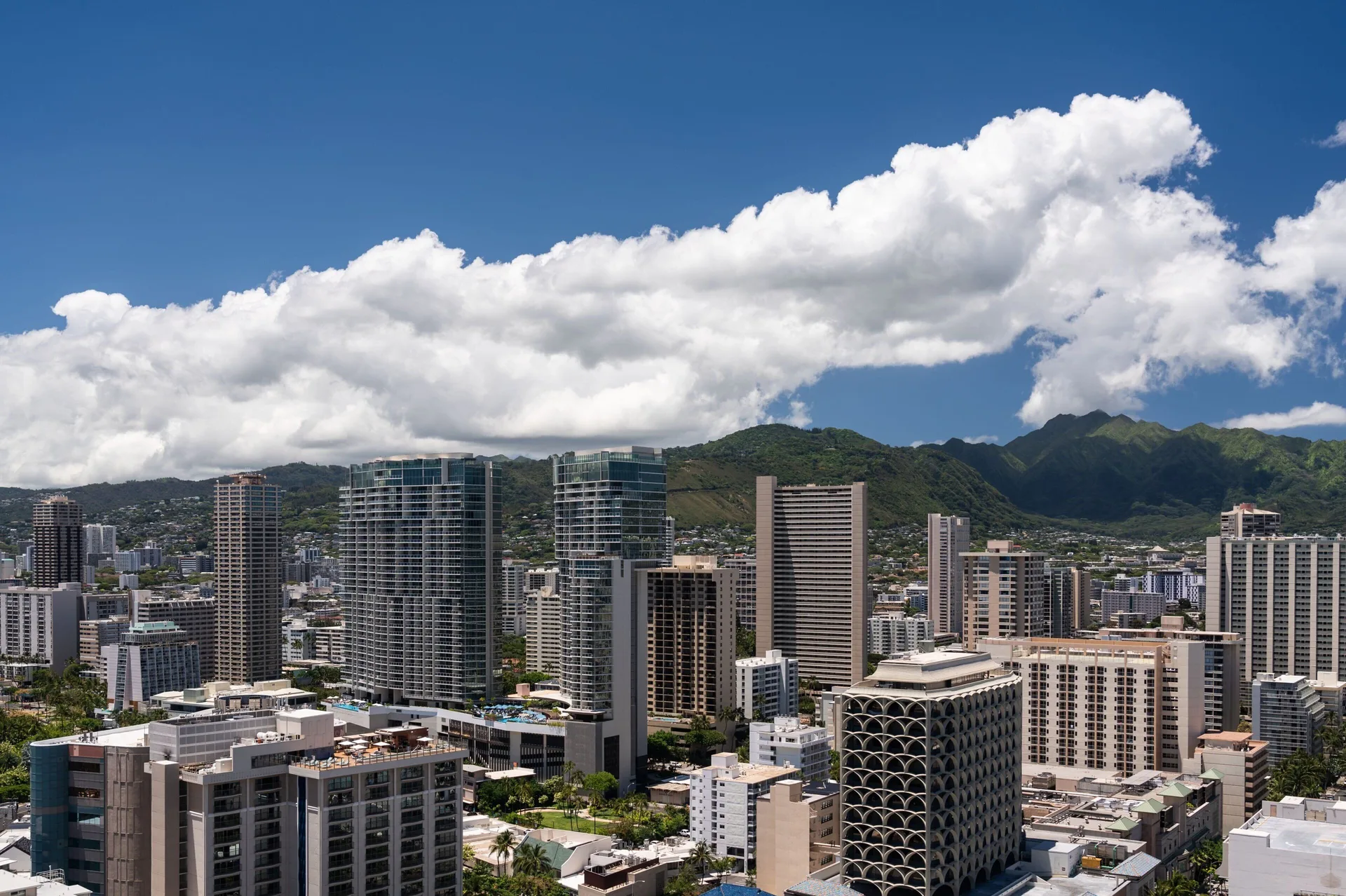 City View room outlook over Honolulu towers and mountains at Sheraton Waikiki Beach Resort.