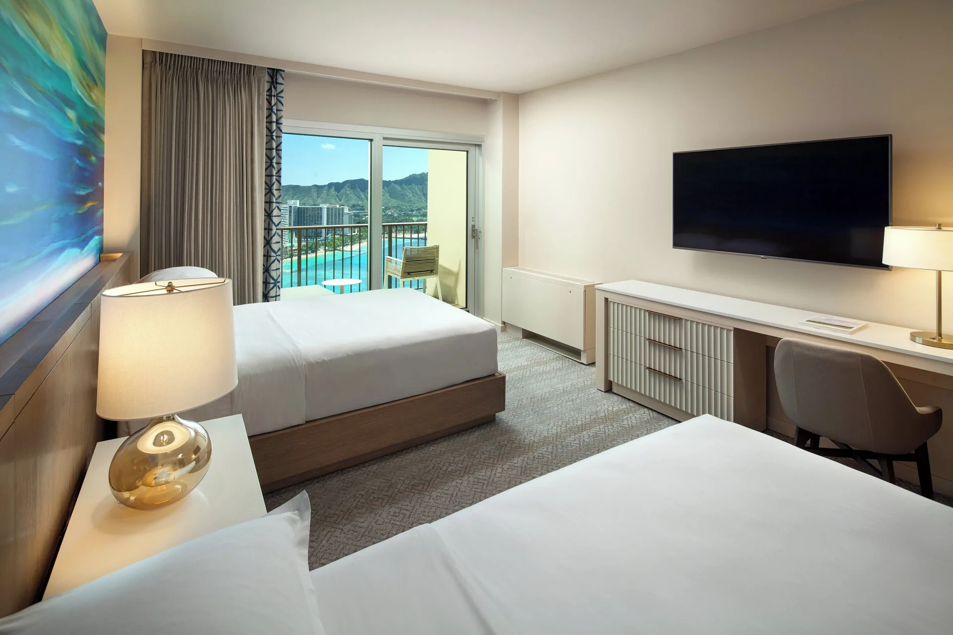 Oceanfront Diamond Head room with two beds and balcony at Sheraton Waikiki Beach Resort.