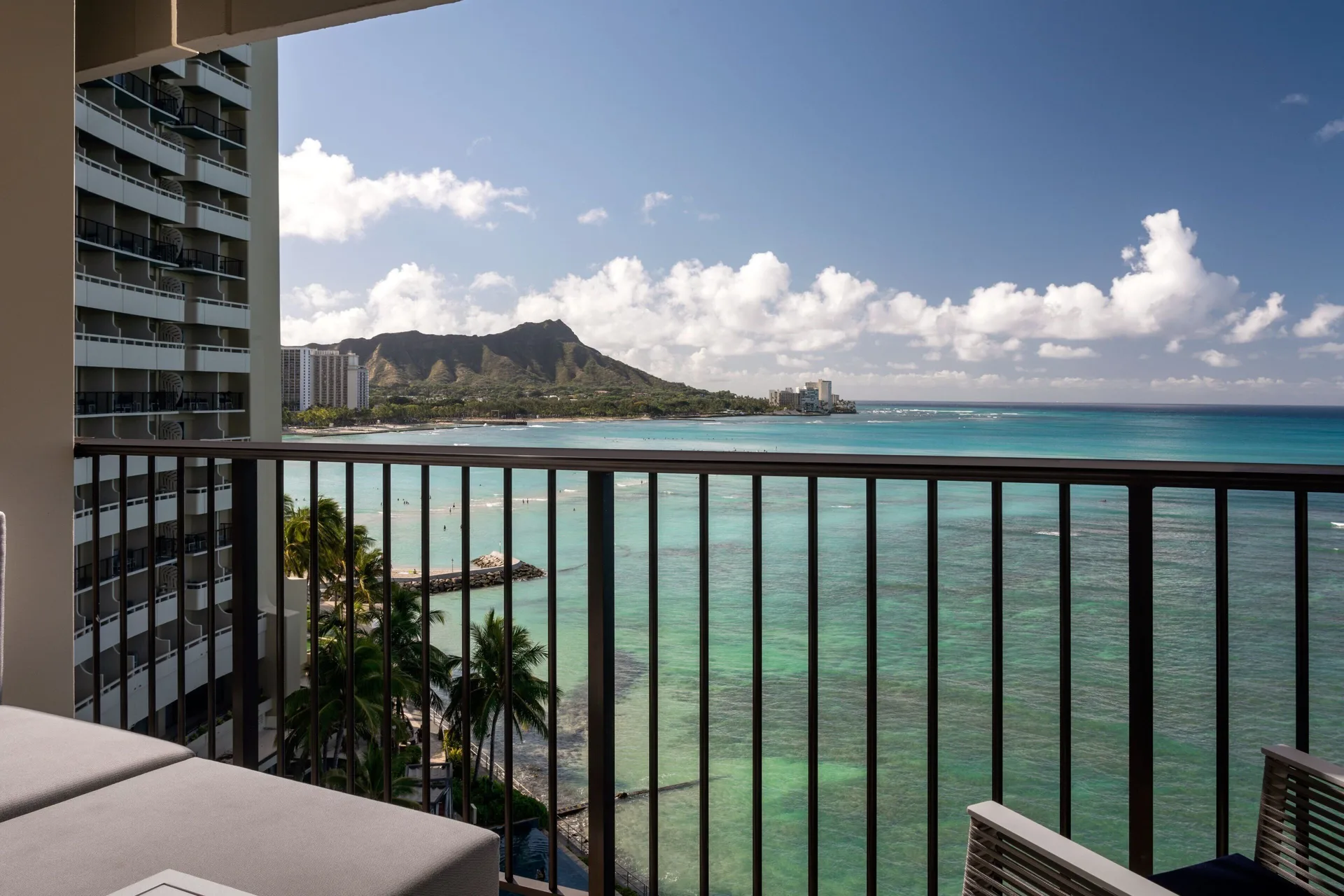 Oceanfront room balcony view of Waikiki and Diamond Head at Sheraton Waikiki Beach Resort.