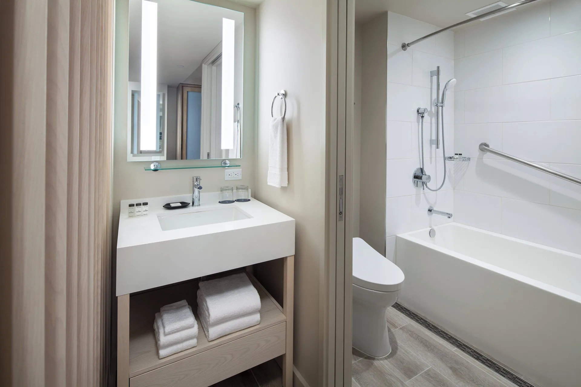 Oceanfront room bathroom with vanity and tub at Sheraton Waikiki Beach Resort.