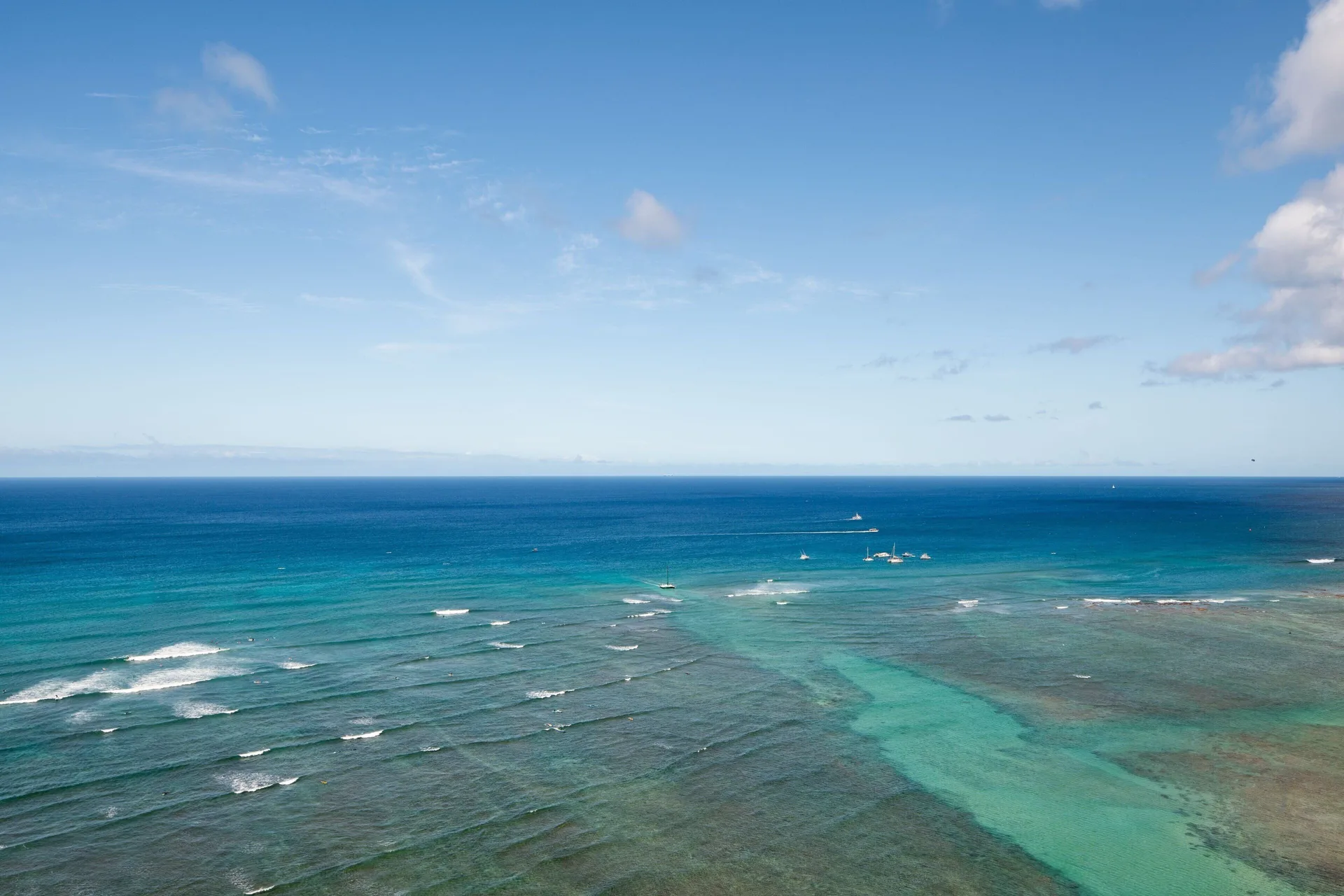 Open ocean and reef view from Sheraton Waikiki Beach Resort with sailboats in the distance.