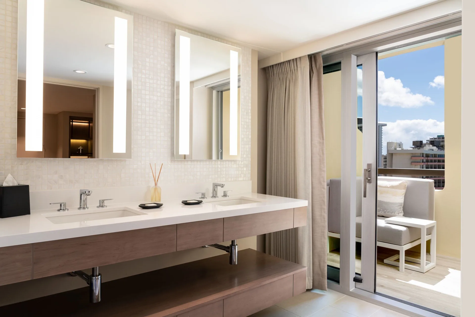 Malia Suite bathroom vanity opening to a balcony at Sheraton Waikiki Beach Resort.