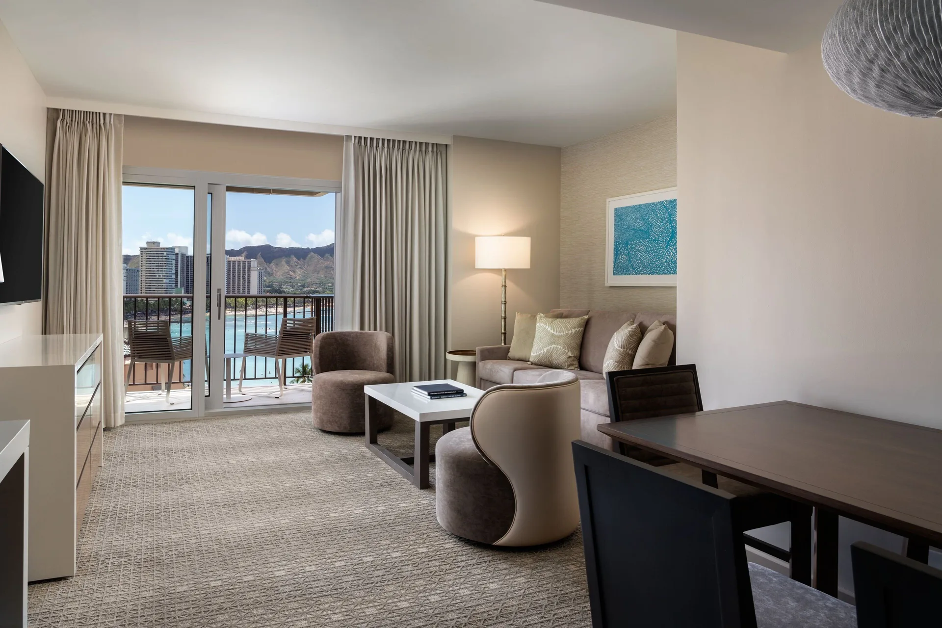 Malia Suite living room facing balcony and ocean view at Sheraton Waikiki Beach Resort.
