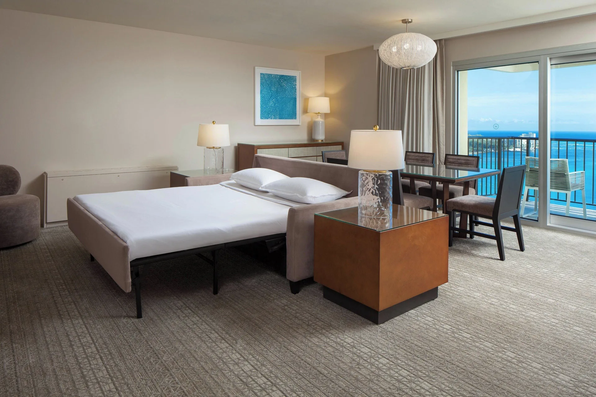 Oceanfront suite living room with sleeper sofa at Sheraton Waikiki Beach Resort.