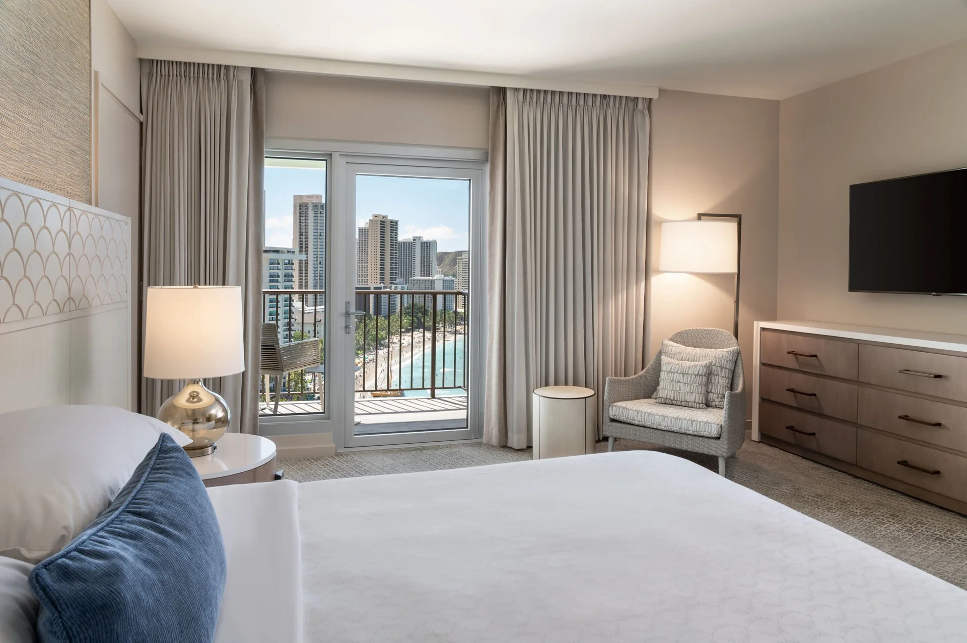Oceanfront Kai Suite bedroom with balcony view at Sheraton Waikiki Beach Resort.