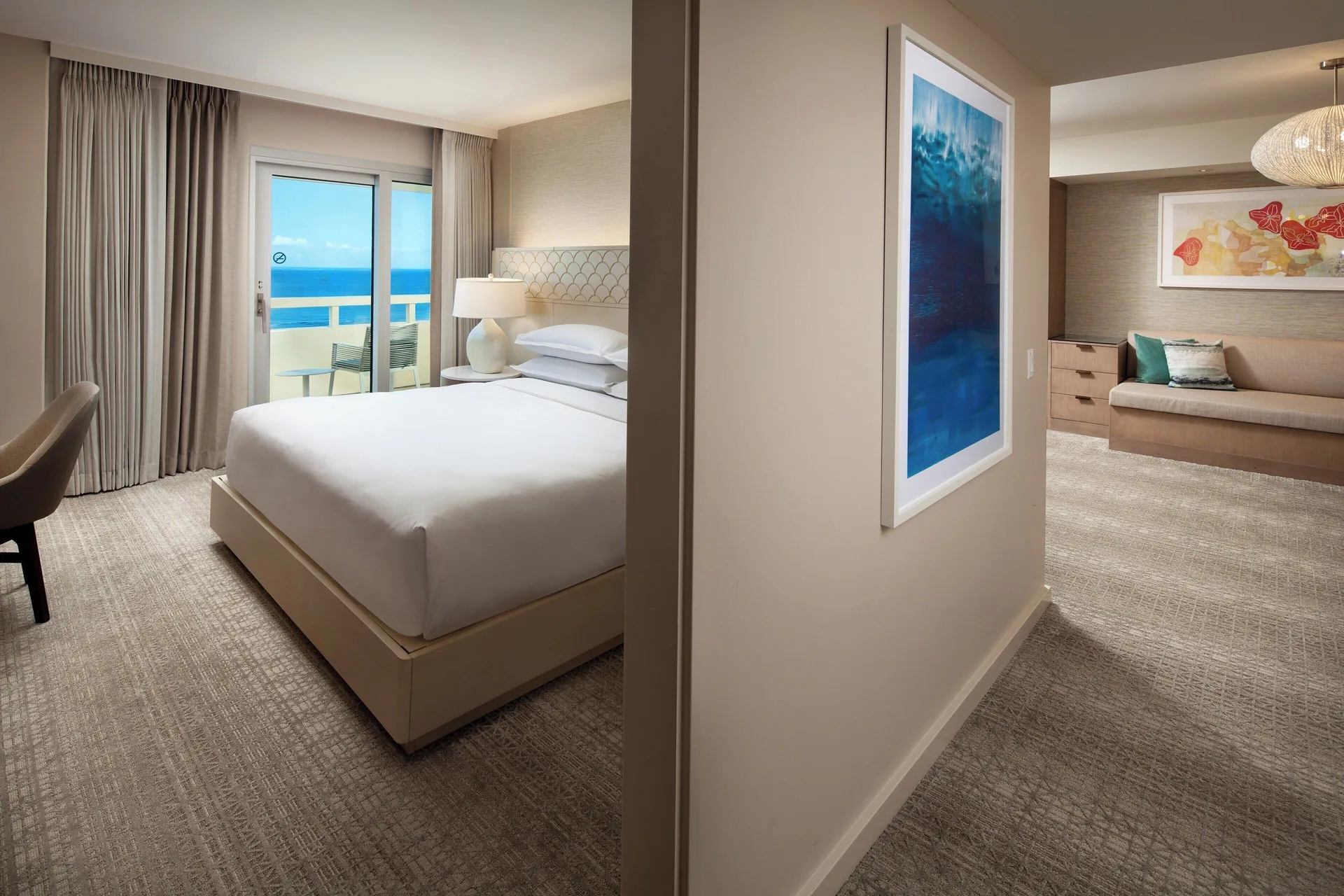 Ohana Suite hallway at Sheraton Waikiki Beach Resort showing a bedroom and sitting area.