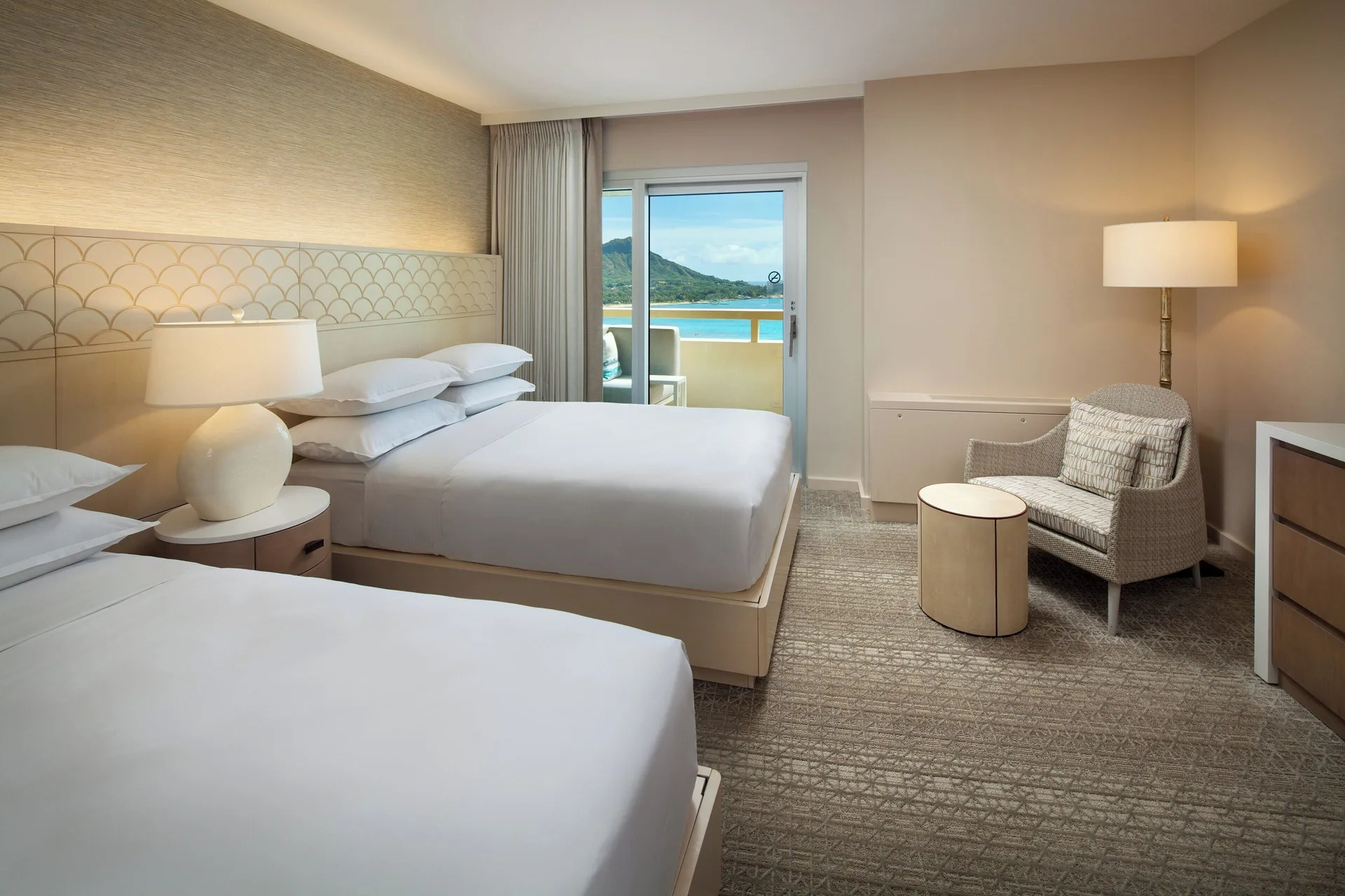 Two-bed bedroom in the Ohana Suite at Sheraton Waikiki Beach Resort with balcony and ocean view.