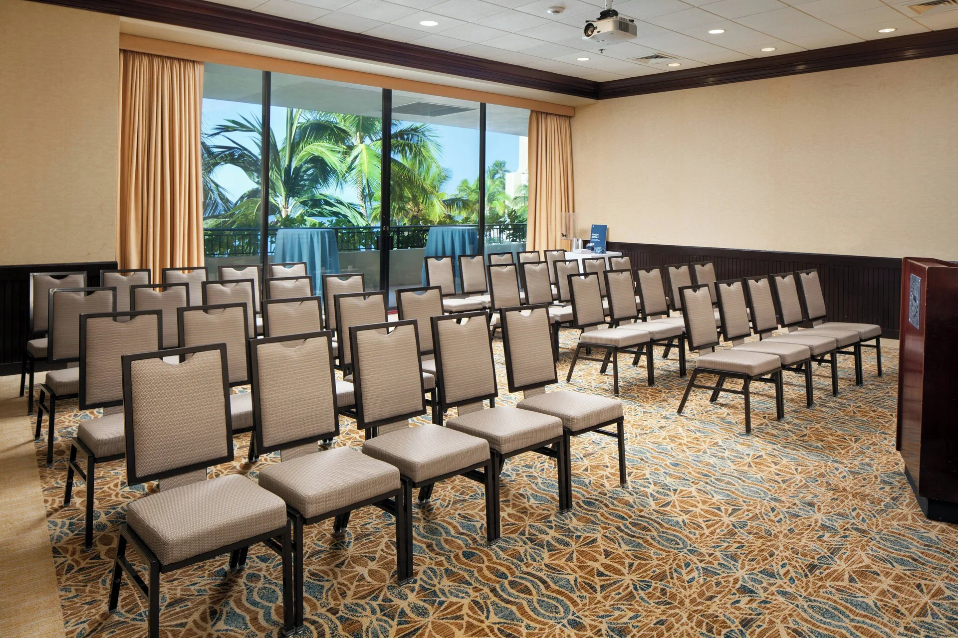 Meeting room with theater-style chairs and balcony windows at Sheraton Waikiki Beach Resort.