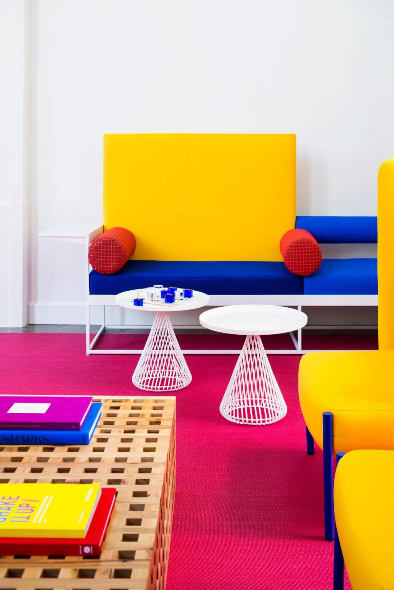 Colorful lobby lounge with yellow and blue seating at Shoreline Hotel Waikiki.