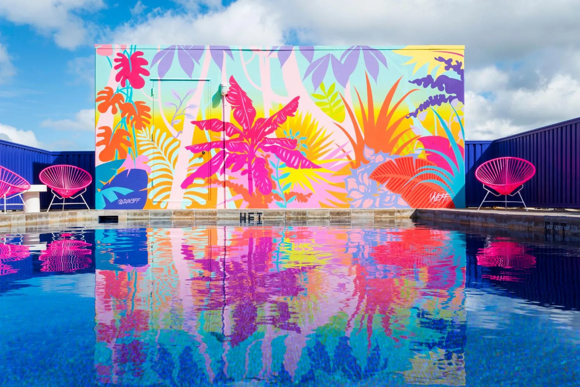 Rooftop pool reflecting a colorful tropical mural at Shoreline Hotel Waikiki.