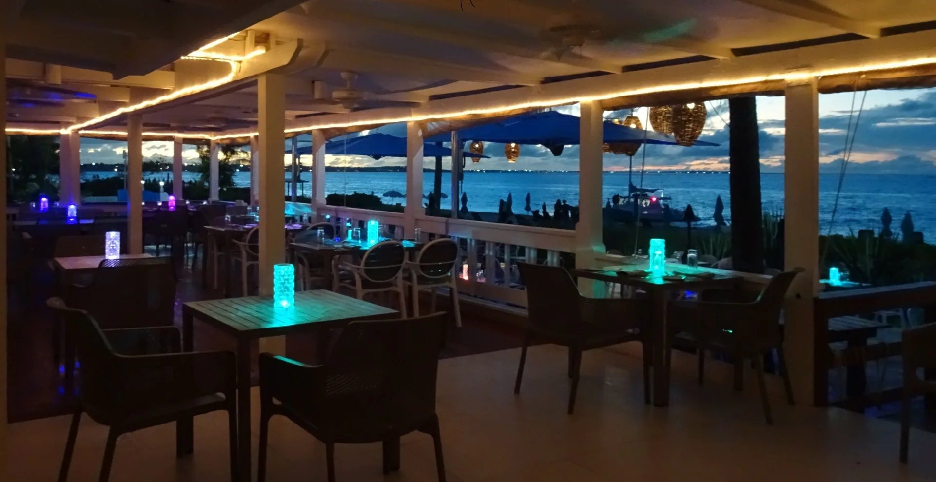 Open-air oceanview dining terrace at Sibonné Beach Hotel at dusk.