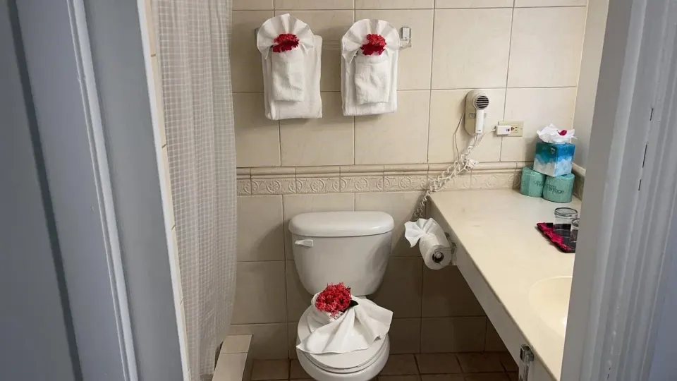 Balcony Room bathroom with towels and counter at Sibonné Beach Hotel.