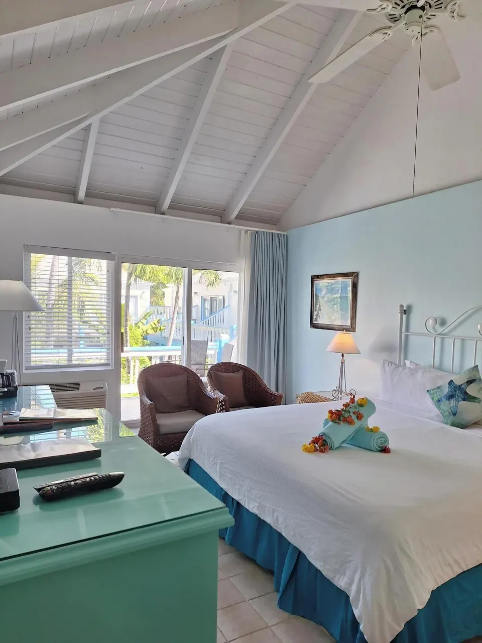 Balcony Room king bed near glass balcony doors and garden view at Sibonné Beach Hotel.
