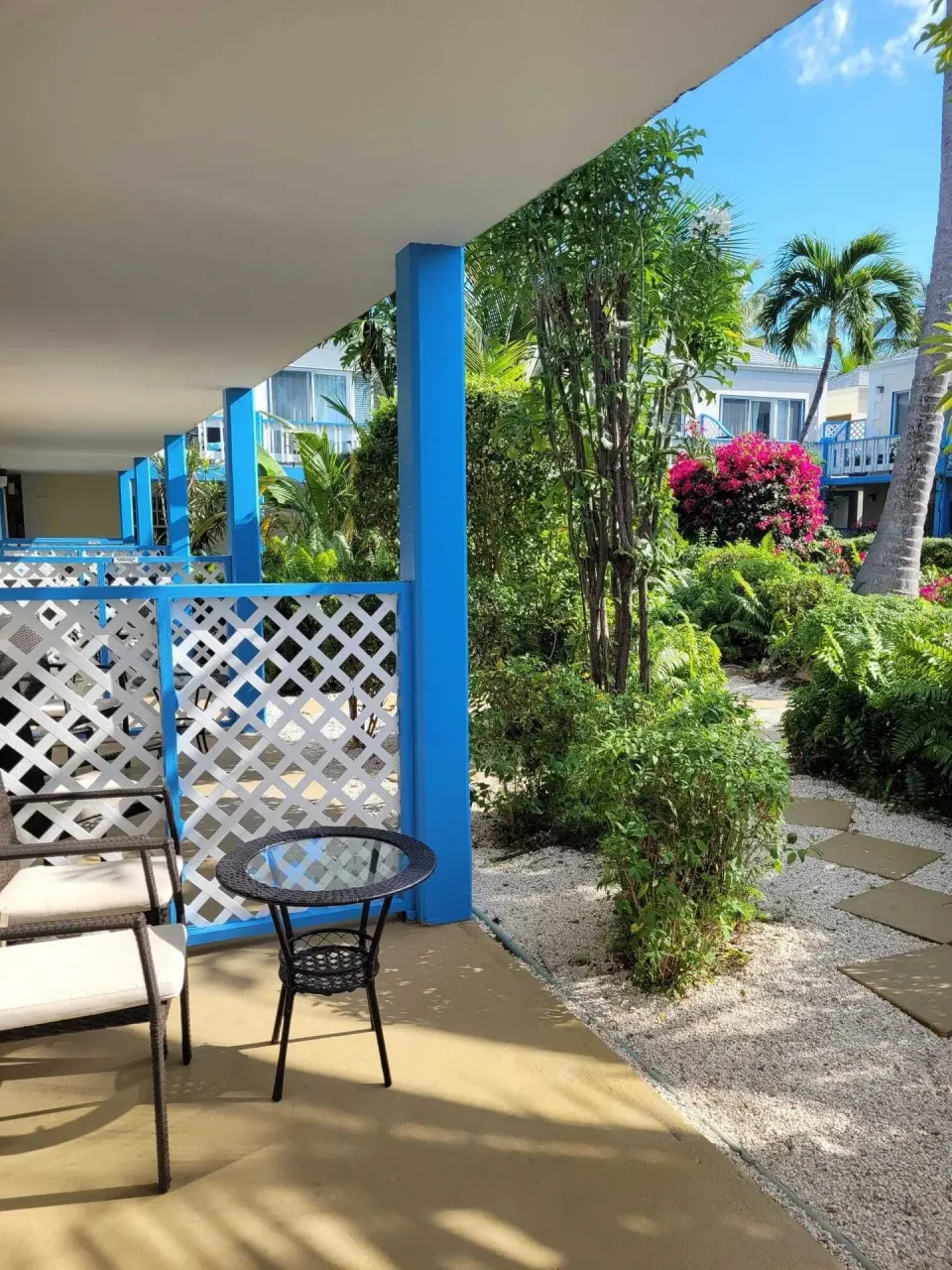 Courtyard View room patio overlooking tropical gardens at Sibonné Beach Hotel.