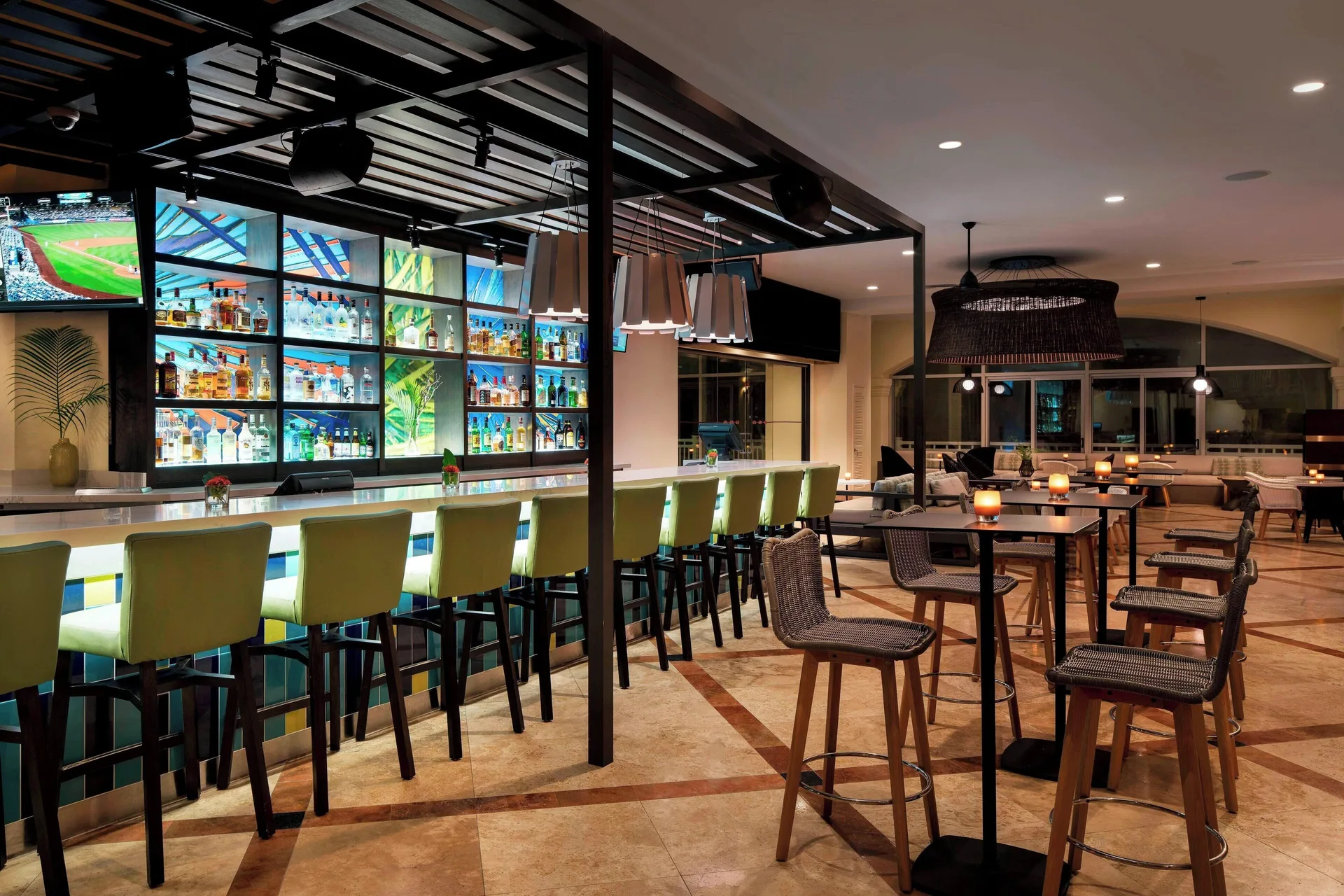 Lobby bar with green stools and bottle displays at St Kitts Marriott Beach Resort, Casino & Spa.