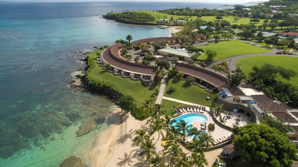 Aerial view of oceanfront rooms by the coast at The Buccaneer Beach & Golf Resort.