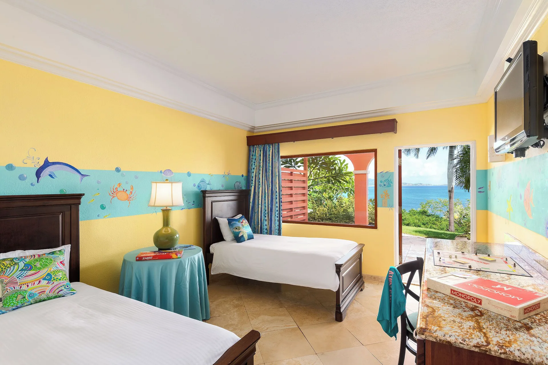 Family Suite cottage kids bedroom with twin beds and ocean view at The Buccaneer Beach & Golf Resort.