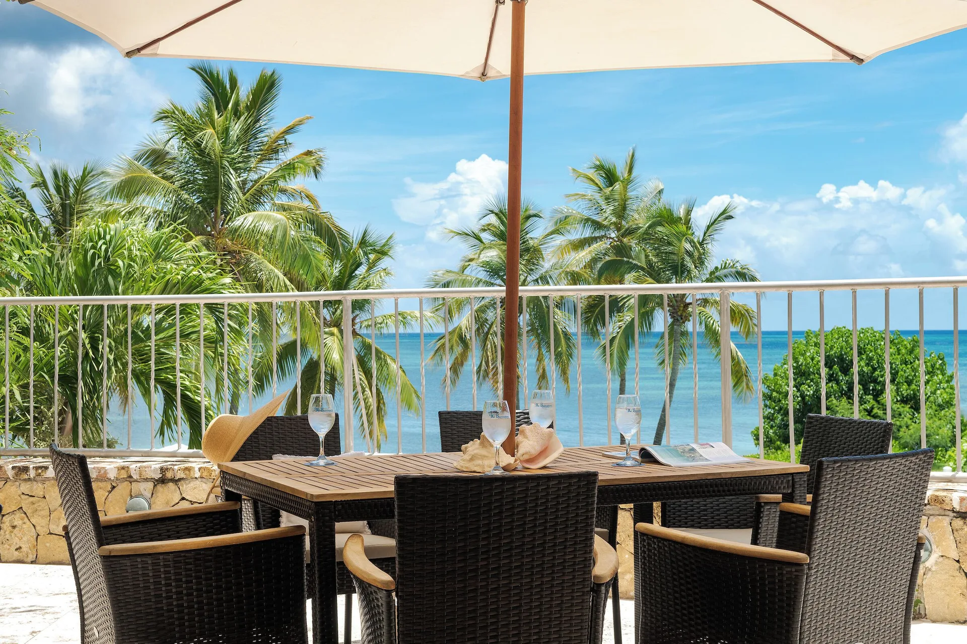 Ficus Suite terrace dining table with ocean view at The Buccaneer Beach & Golf Resort.