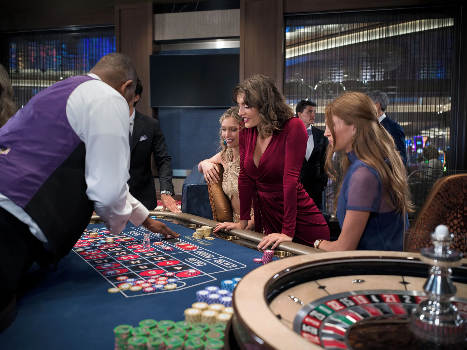 Guests gather at a roulette and table game area at The Coral at Atlantis.