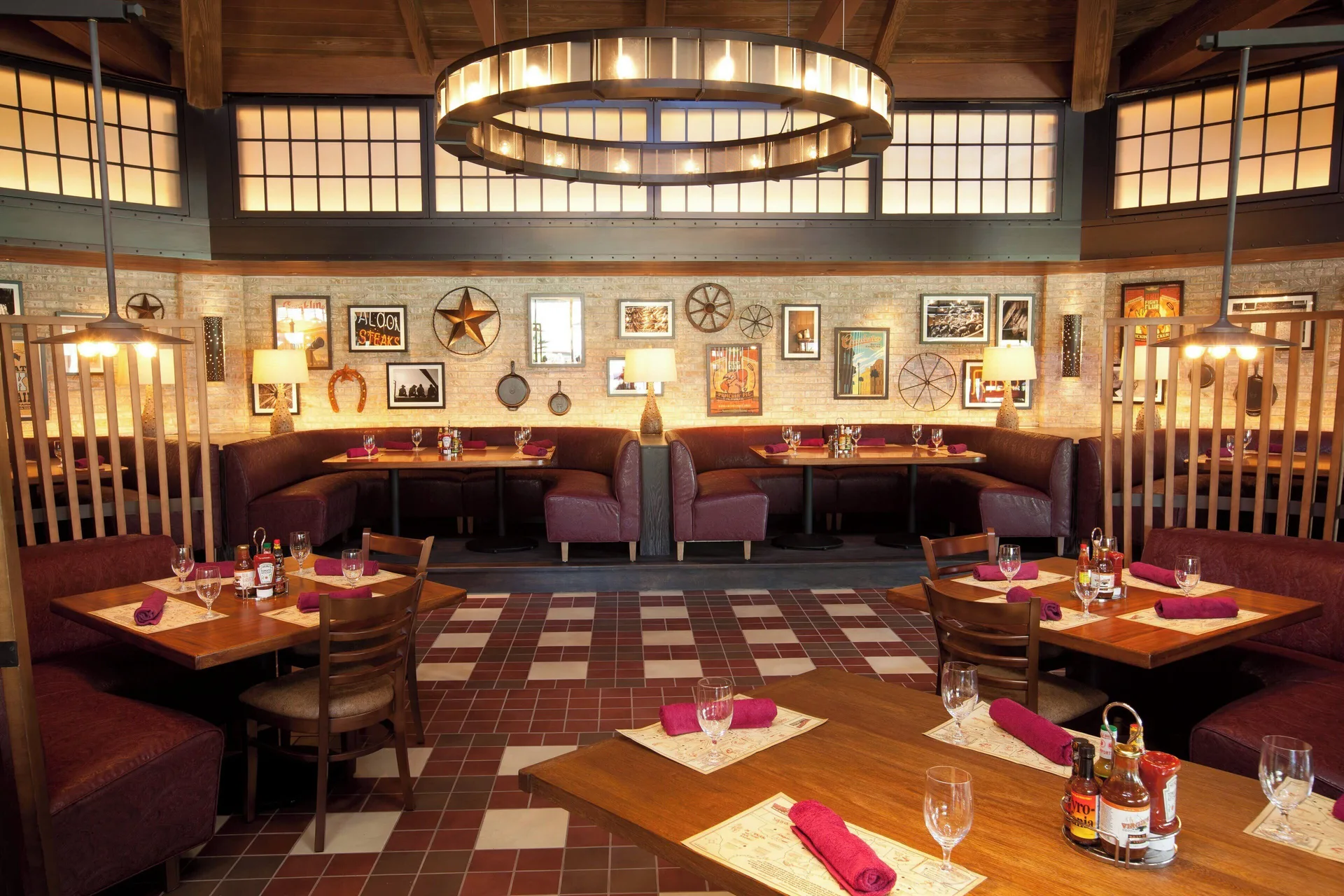 Casual restaurant dining room with booths and set tables at The Coral at Atlantis.
