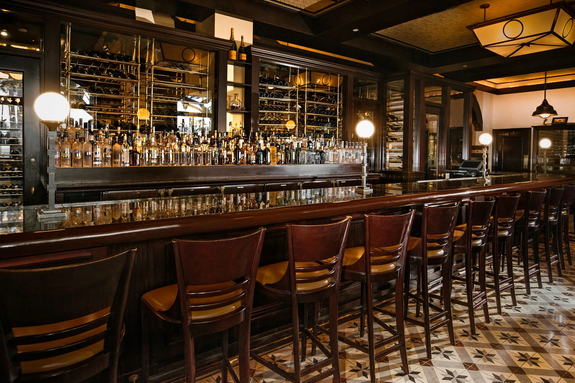 Long polished bar with stools and bottle displays at The Coral at Atlantis.