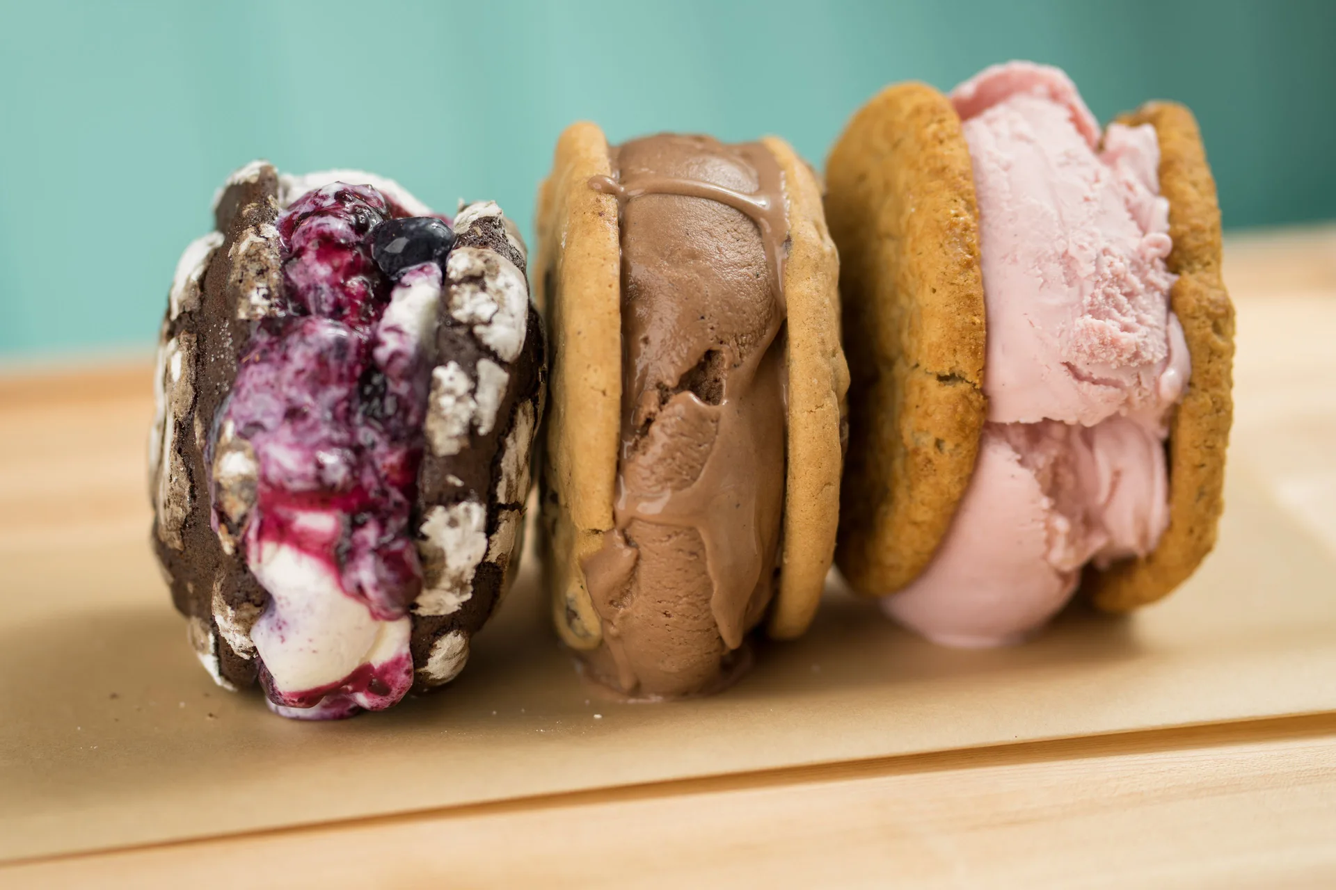 Three ice cream cookie sandwiches on a wooden board at The Coral at Atlantis.