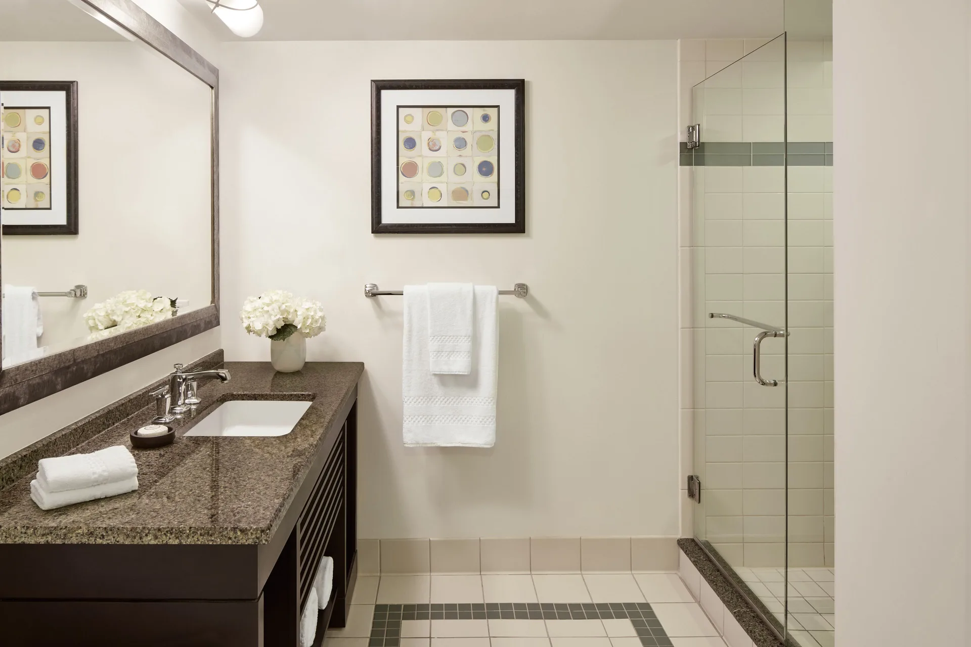 Bathroom in a 1 Bedroom Regal Suite at The Coral at Atlantis with vanity and glass shower.