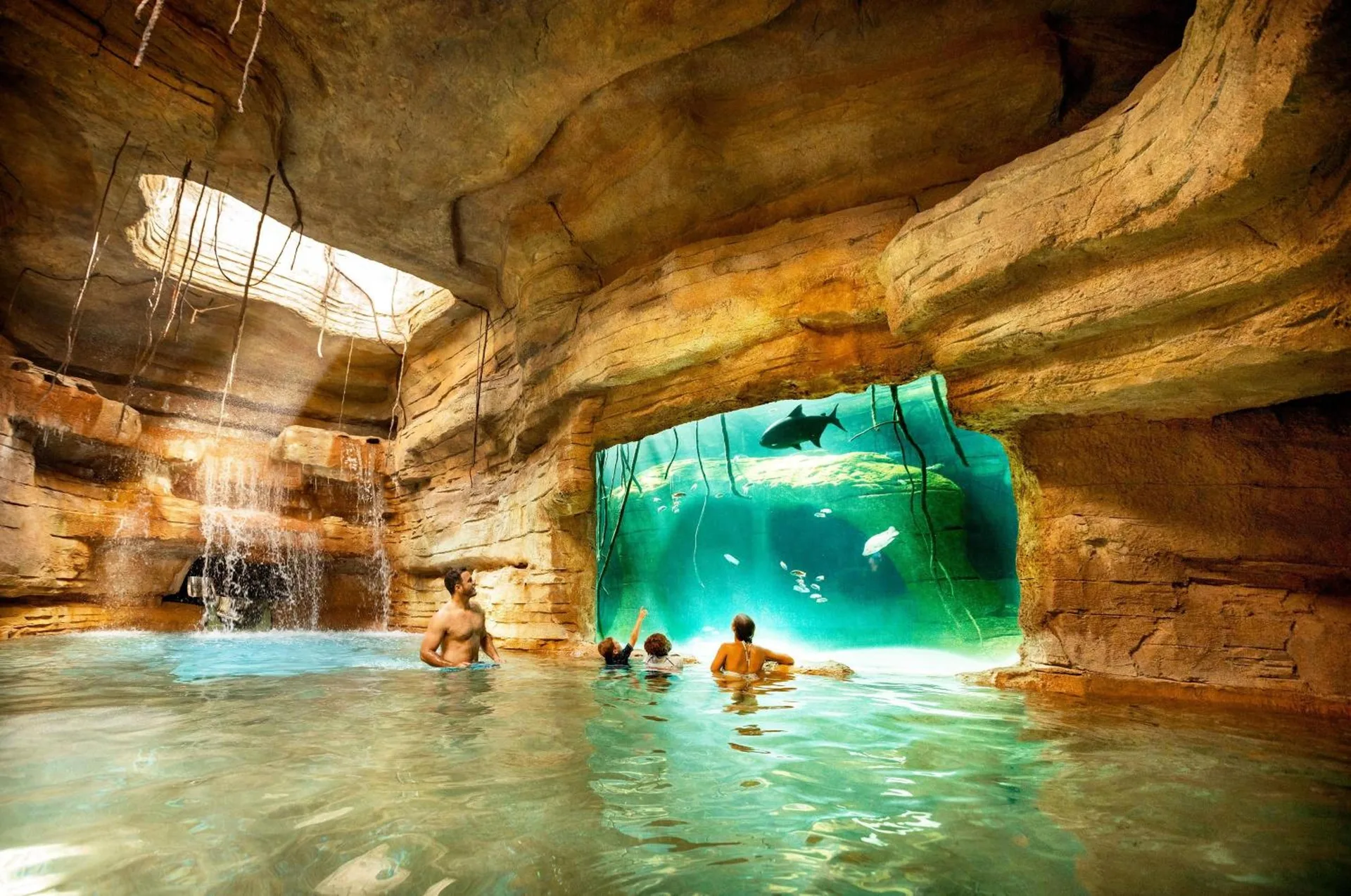 Indoor pool grotto with aquarium window at The Coral at Atlantis.