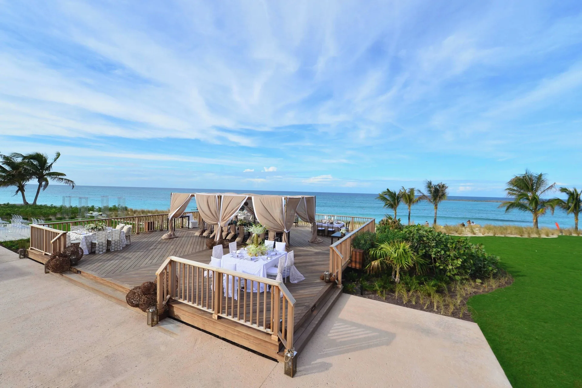 An oceanfront event deck with draped cabanas at The Coral at Atlantis.