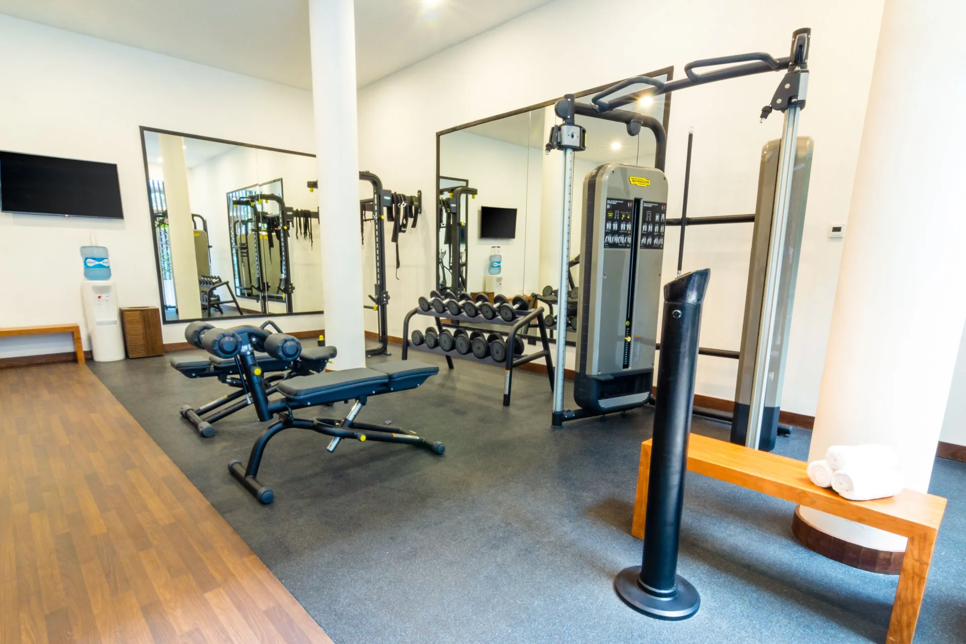 Fitness room with strength machines and free weights at The Fives Oceanfront Riviera Maya.