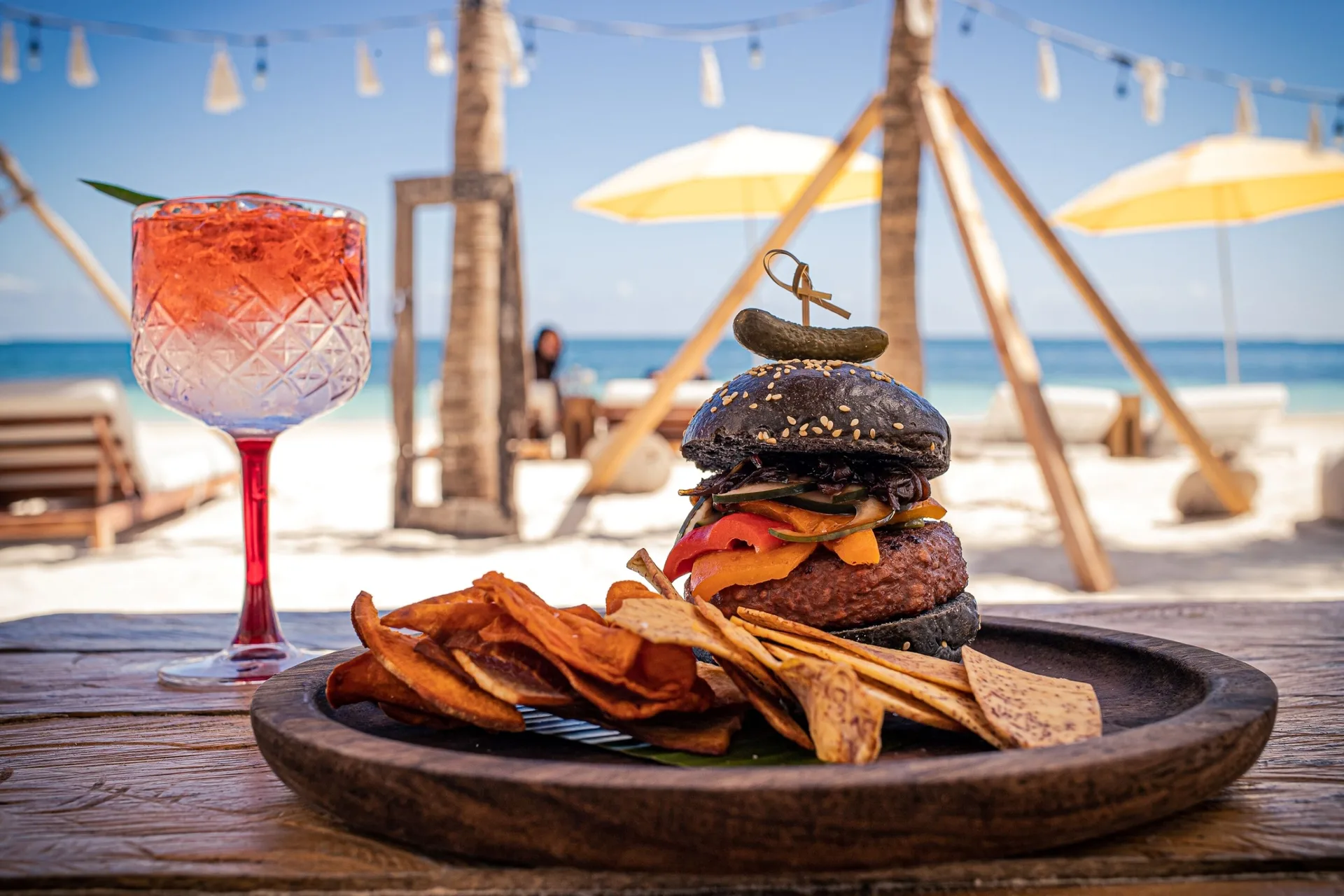Beachside burger, chips, and cocktail at The Fives Oceanfront Riviera Maya.