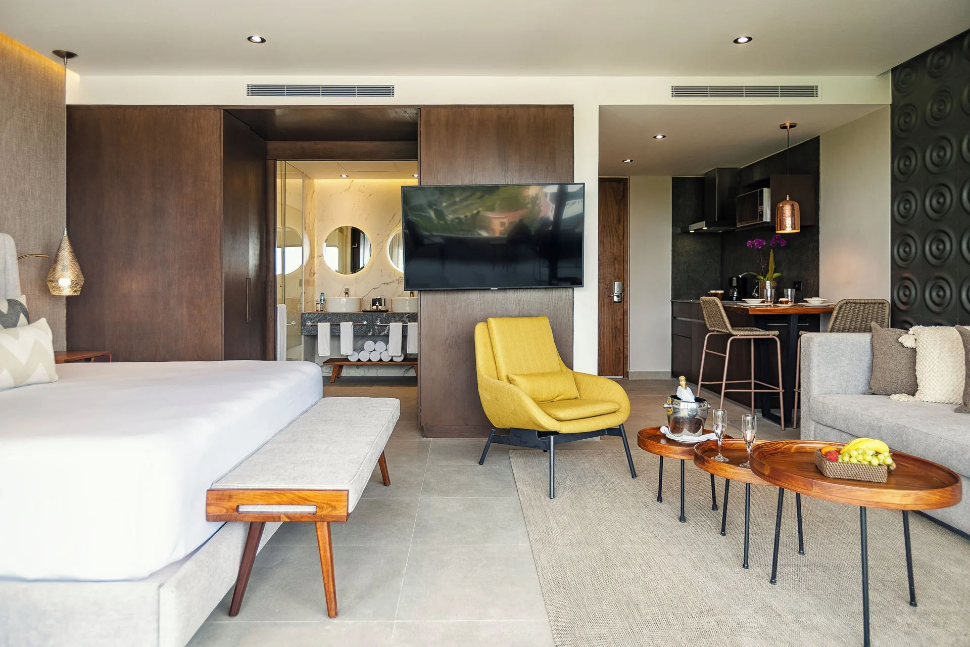 Junior Suite with king bed, sitting area and kitchenette at The Fives Oceanfront Riviera Maya.