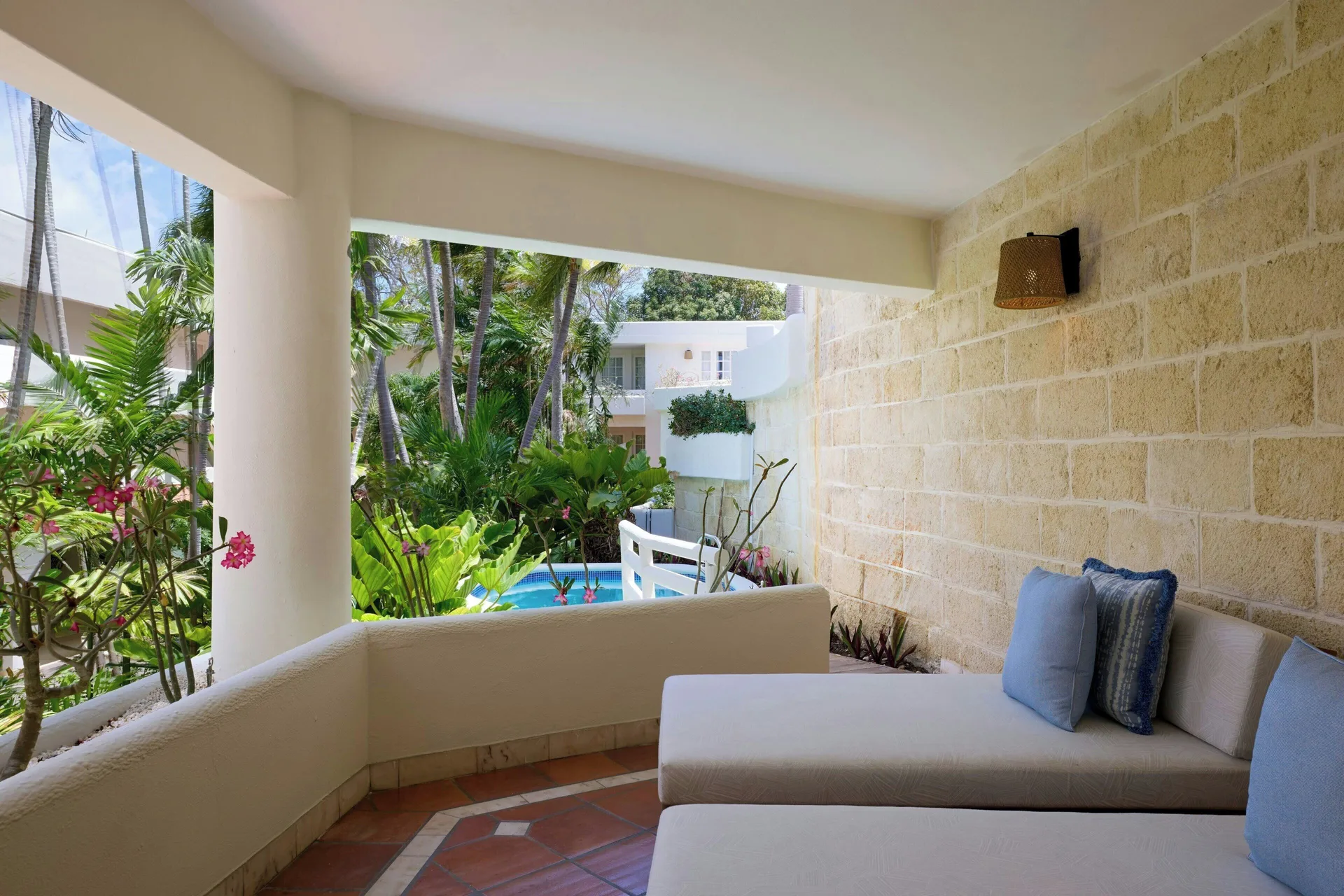 Luxury Garden View terrace with daybeds and tropical garden at The House.