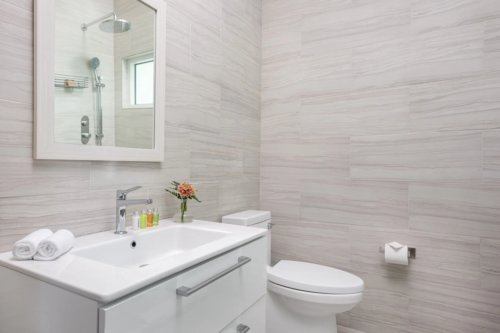 Deluxe Room bathroom vanity and toilet at The Oasis at Grace Bay.