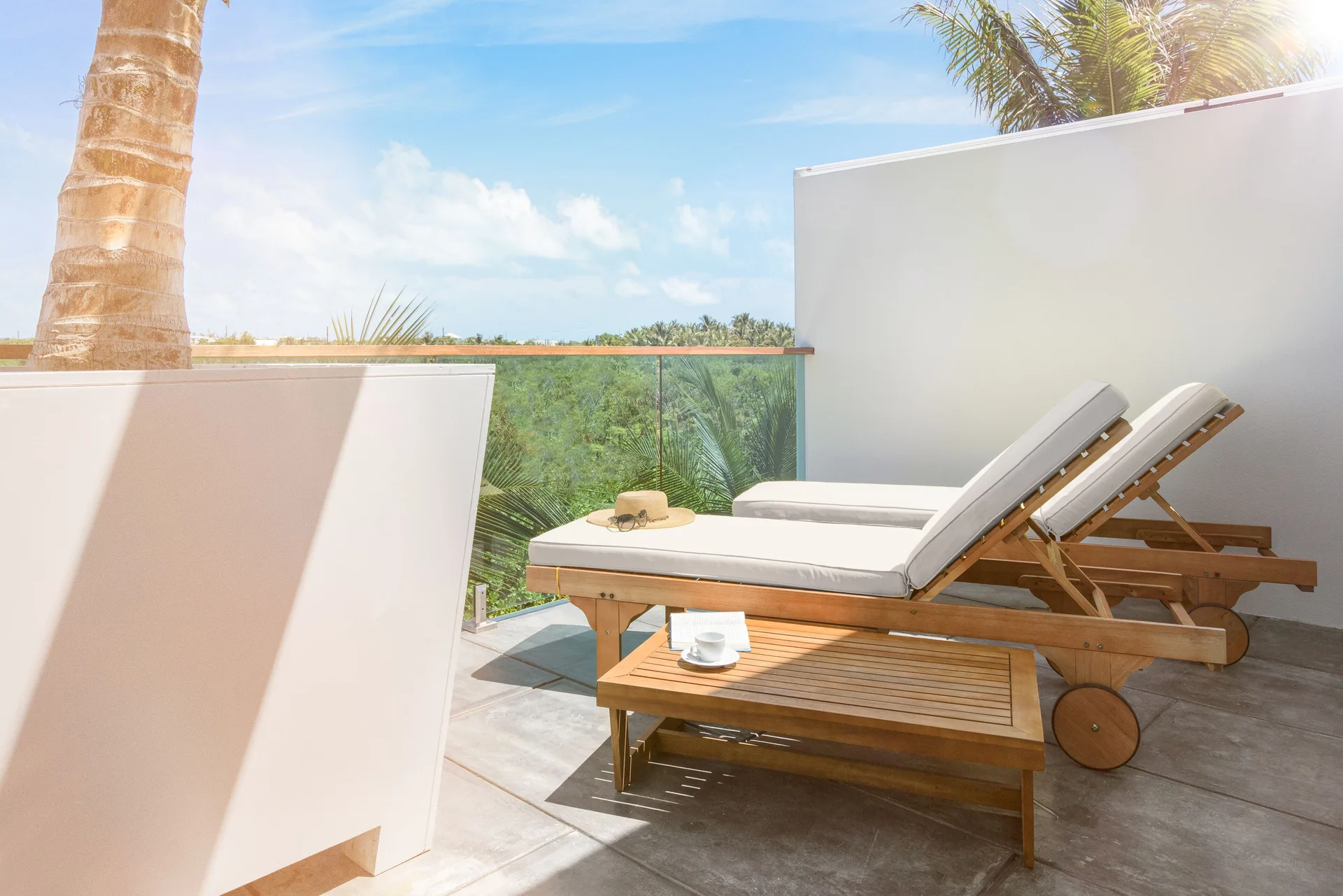 Deluxe Room private terrace with two cushioned loungers at The Oasis at Grace Bay.