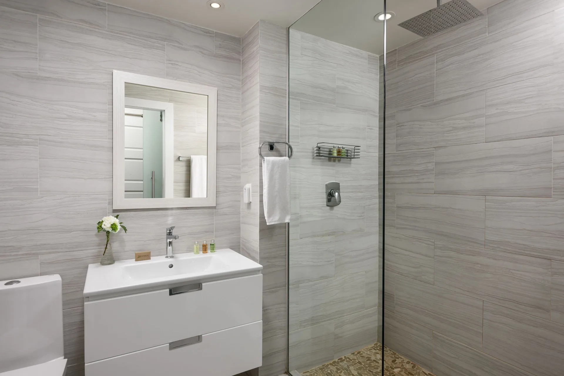 Luxury Room bathroom with vanity and glass shower at The Oasis at Grace Bay.