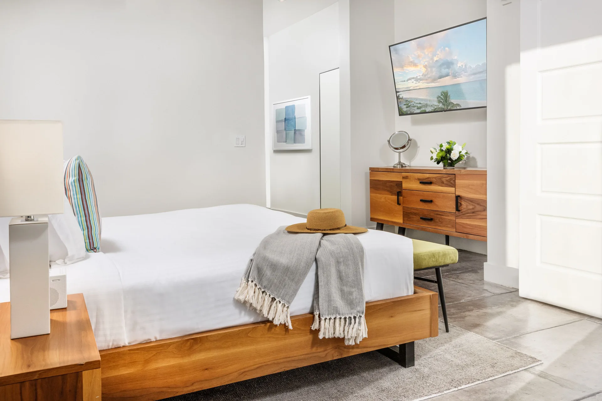 Luxury Room bed with dresser and TV at The Oasis at Grace Bay.