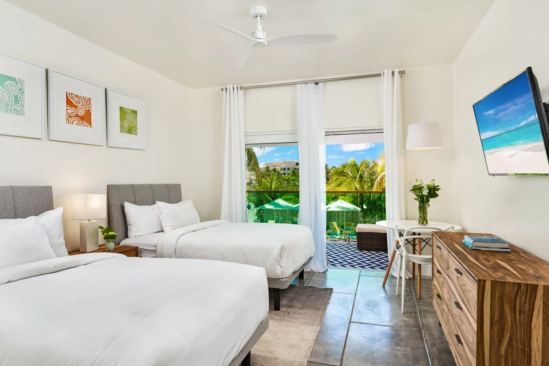 Luxury Room with two beds and balcony view at The Oasis at Grace Bay.