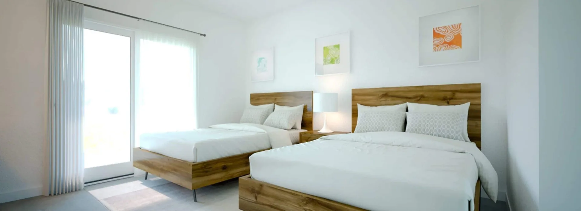 Luxury Room with two wood-frame beds and sliding doors at The Oasis at Grace Bay.