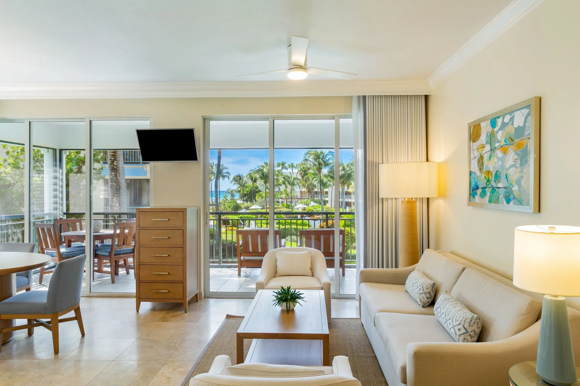 One-bedroom garden view suite living room with balcony doors at The Sands at Grace Bay.