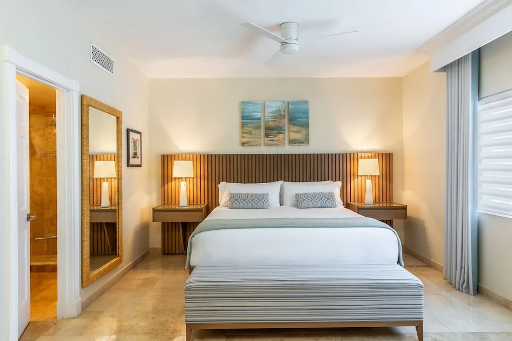 Primary bedroom with king bed in a suite at The Sands at Grace Bay.
