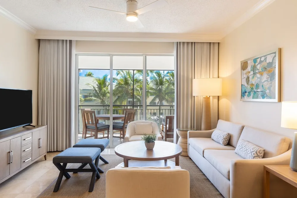 Ocean view suite living room with balcony doors at The Sands at Grace Bay.